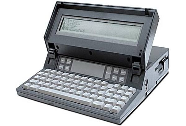 The Gavalin SC portable computer, a grey machine with a flip-up LCD screen, a keyboard, and a floppy disk drive on the right side.