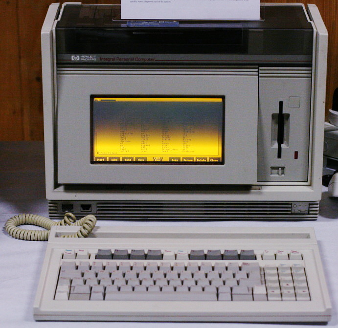The HP Integral PC, a portable computer featuring a detachable keyboard, a small black-and-amber screen, and a 3.5-inch flopp disk drive attached to the side of the monitor.