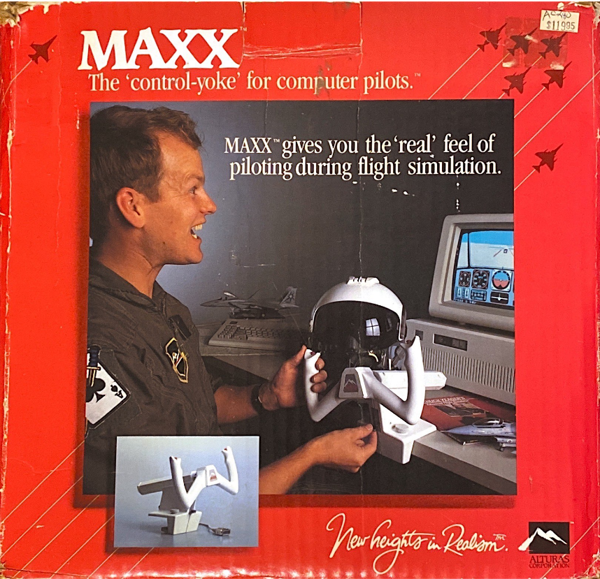 The front box cover of the Maxx control-yoke. There is a picture of a man dressed in a flight suit using the controller to play a flight simulator running on an IBM Personal Computer. The slogan at the bottom of the box reads, “New Heights in Realism.”