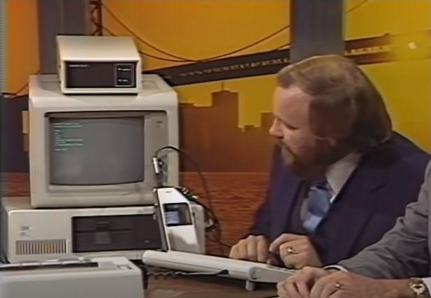 Phil Edholm demonstrates the Sytek LocalNet attached to an IBM Personal Computer.
