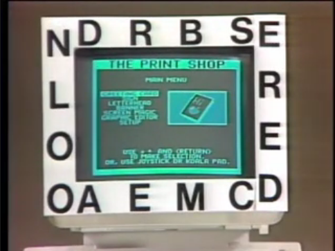 A white template surrounding a green-and-black computer monitor from the 1980s. The template is decorated with a number of letters. On the screen, a copy of Broderbund&rsquo;s &ldquo;The Print Shop&rdquo; is running and displaying the main menu.